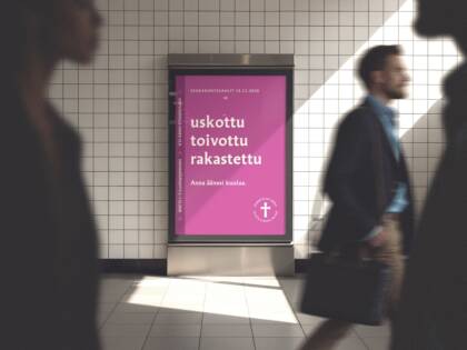 Juliste, jossa on violetti tausta ja teksti "uskottu toivottu rakastettu". Taustalla kulkee ihmisiä, jotka ovat liikkeessä.